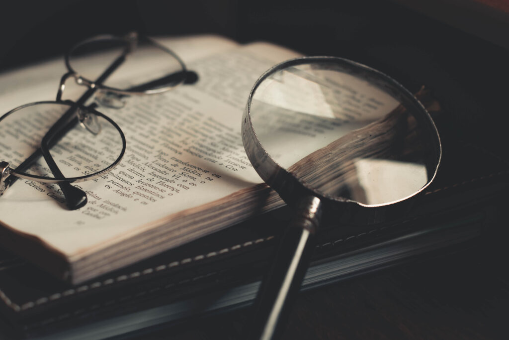 book and magnifying glass